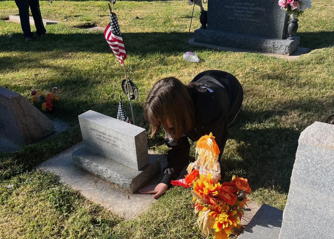 Washington Elementary students cleaned up around the graves of the Veterans after placing flags