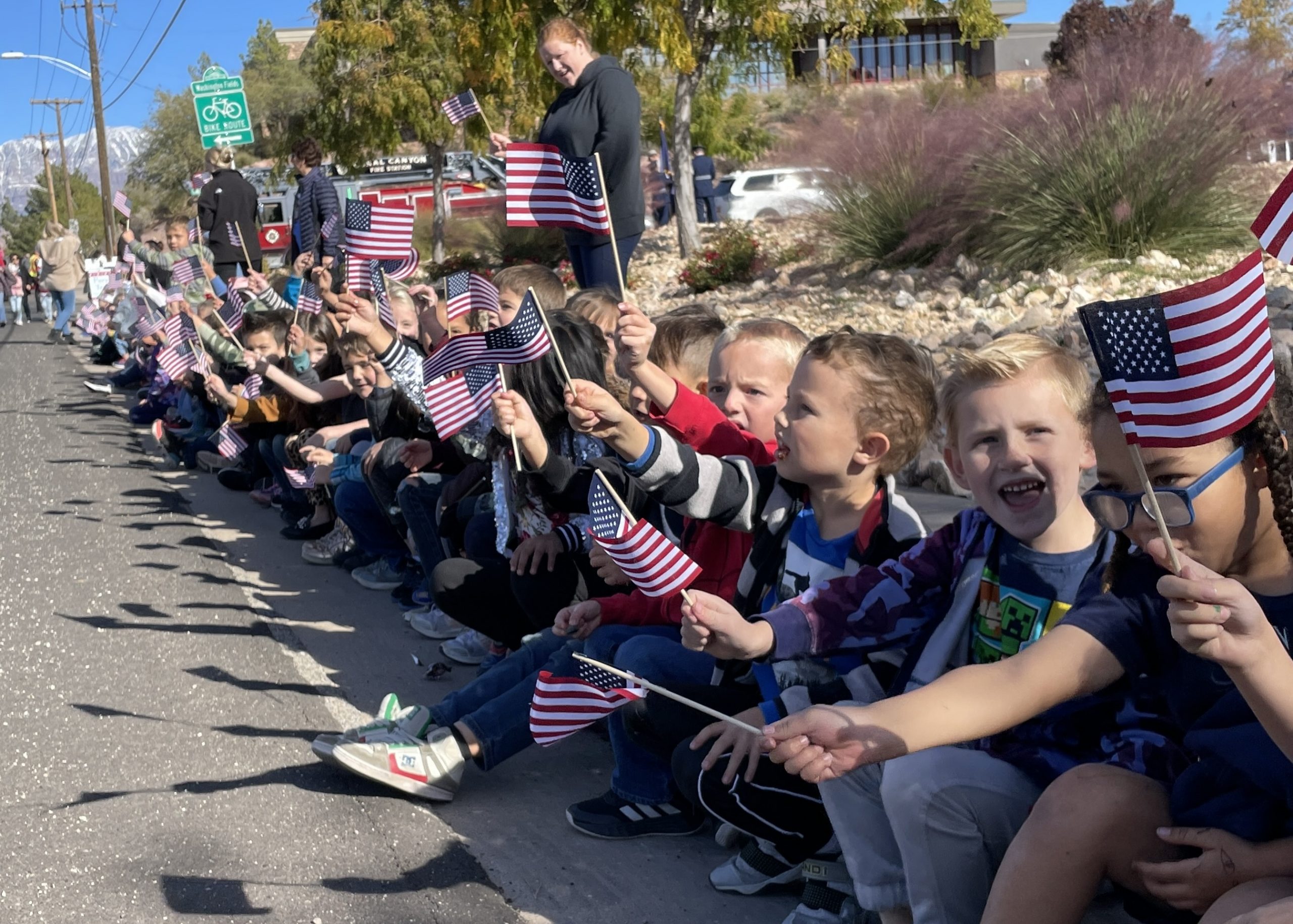 WES Students waving USA Flags at the Veterans Day Parade