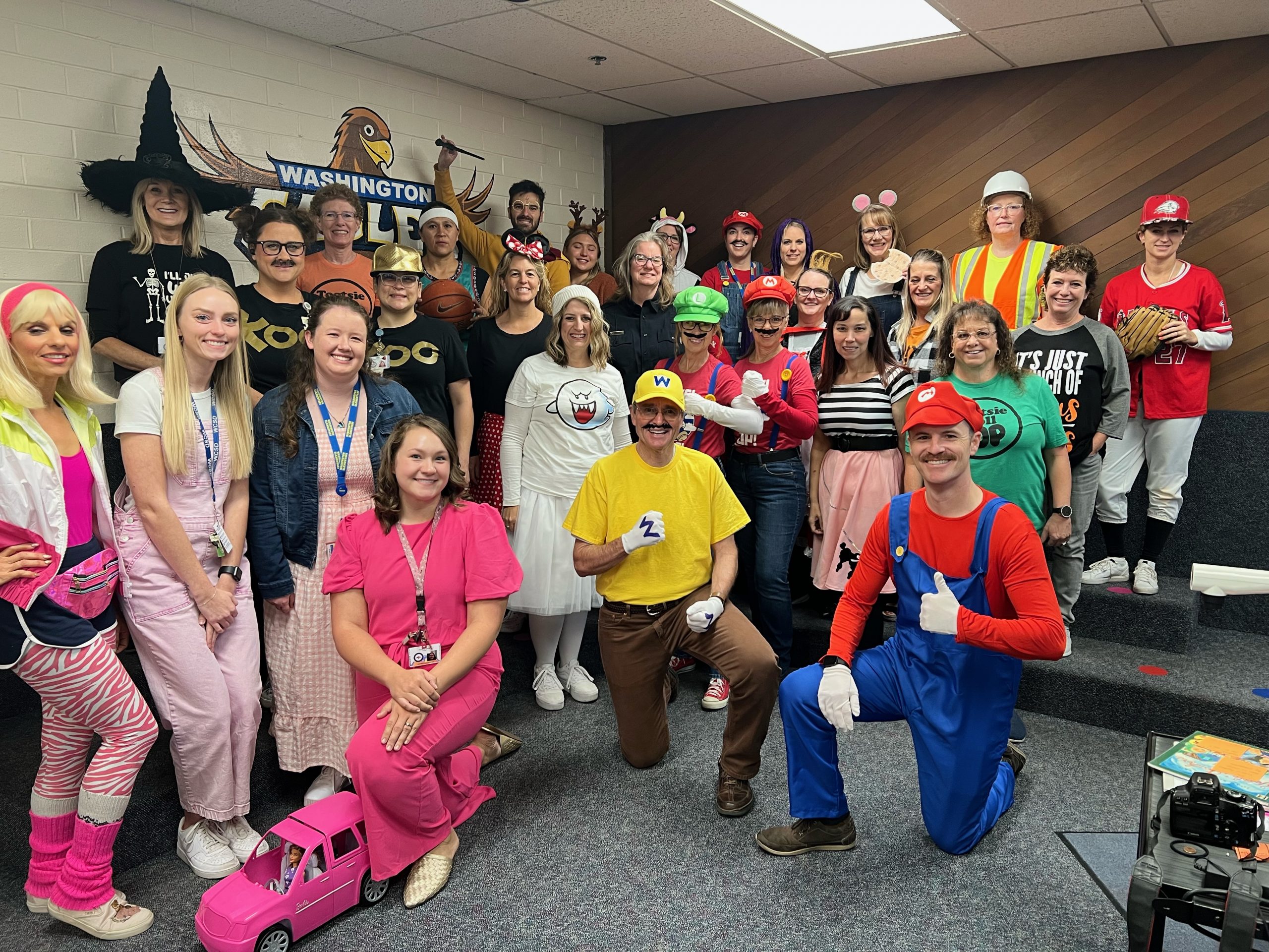 Staff members taking a picture in their Halloween costumes