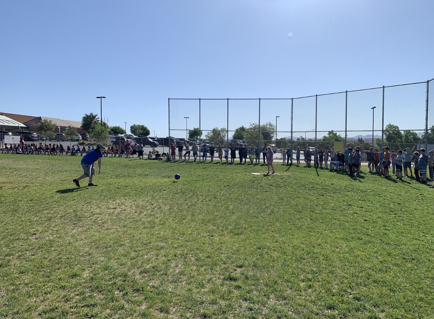 A 5th grader getting ready to kick the ball during the 5th grade vs staff kickball game.