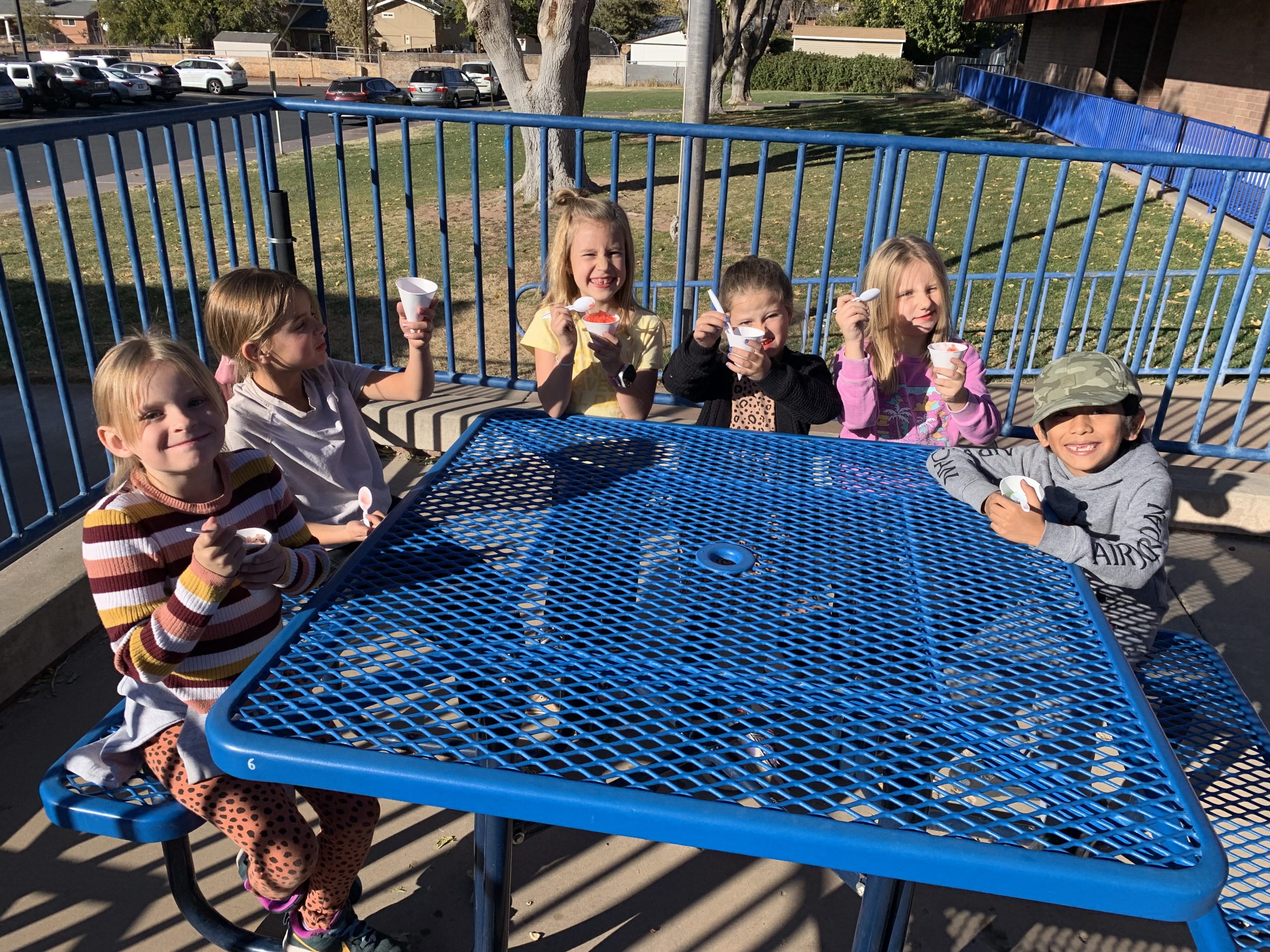 Some of Mrs. Davis's students enjoying snow cones outside the front entrance