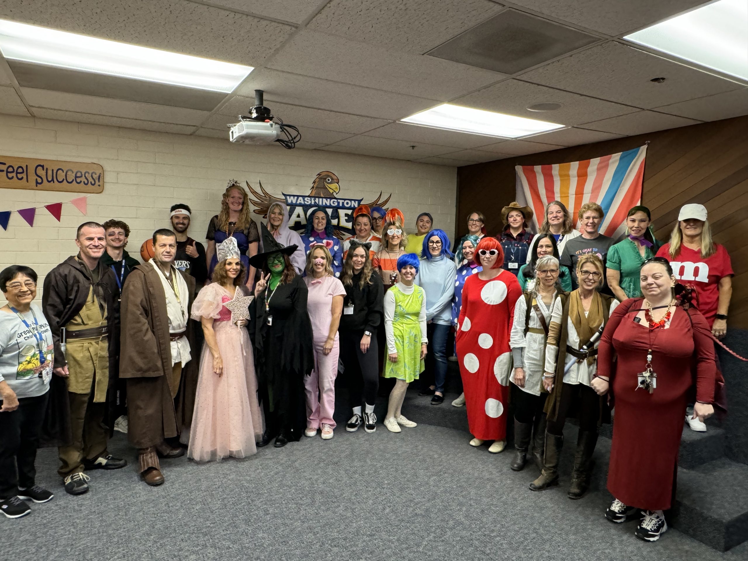 Washington Elementary staff smiling for a staff costume picture