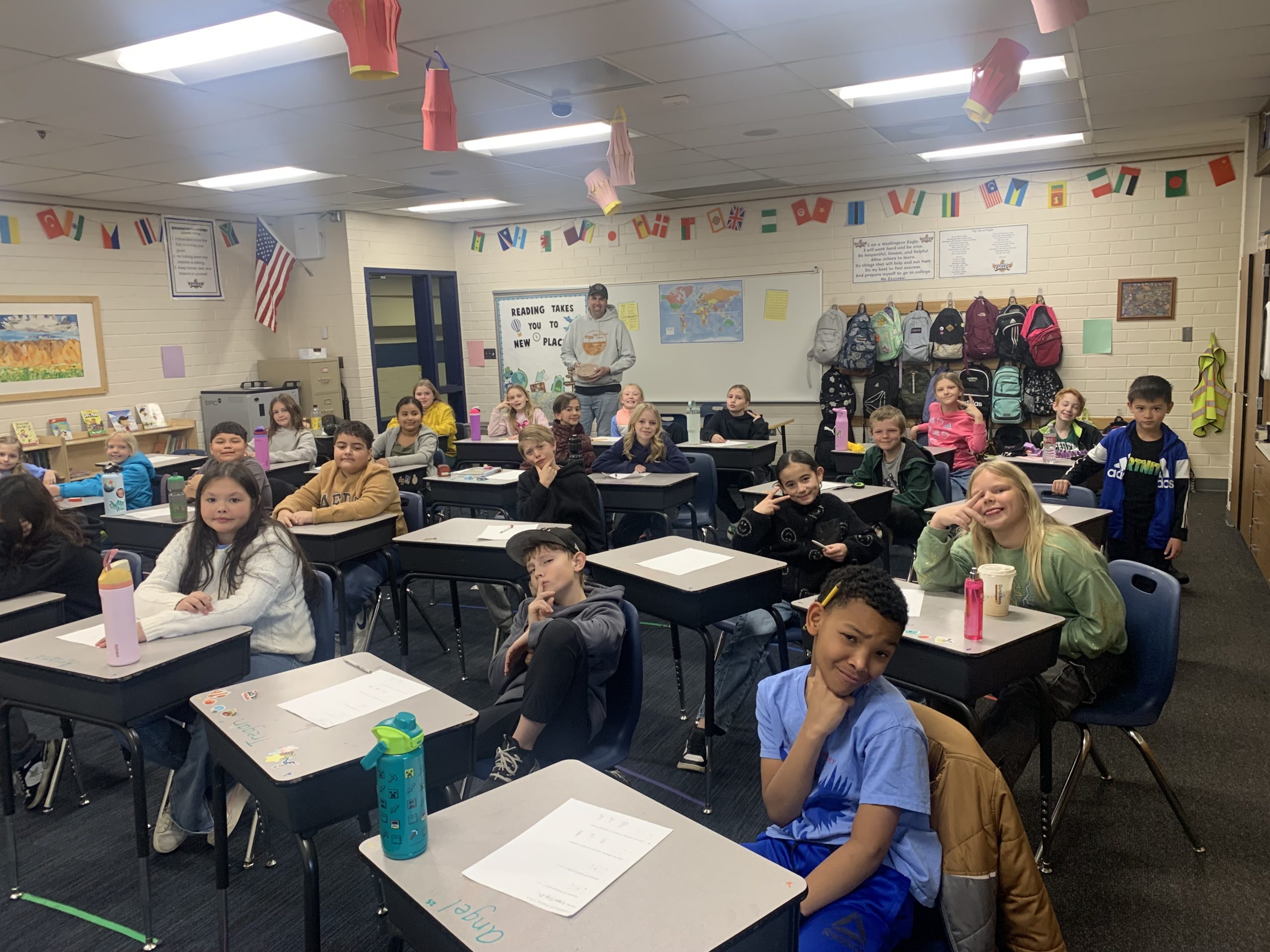 Mr. Barnum's class posing for a picture in the classroom after winning mini-churros