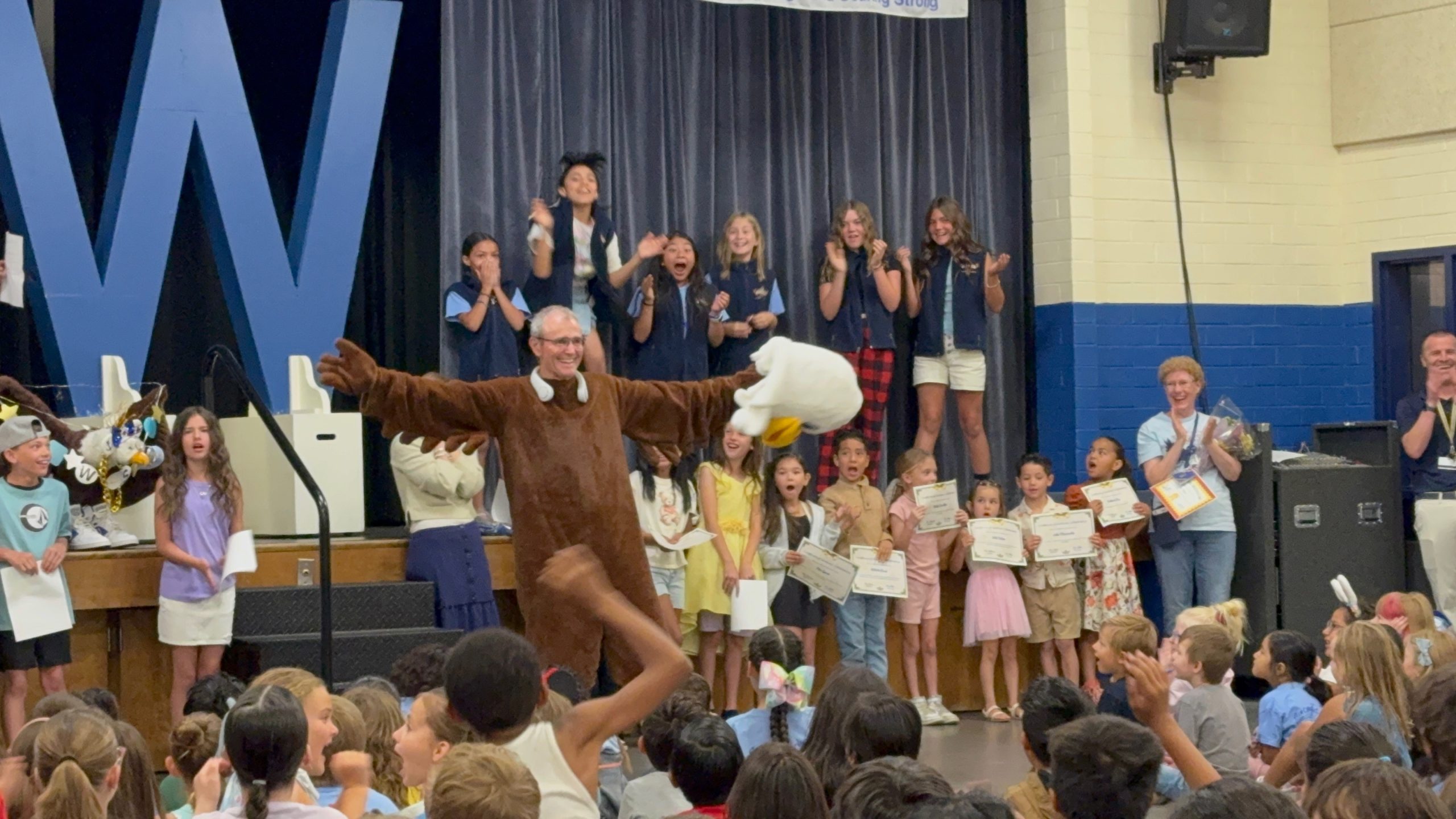 Mr. Mitchell reveals himself to the students as Eddie the Eagle
