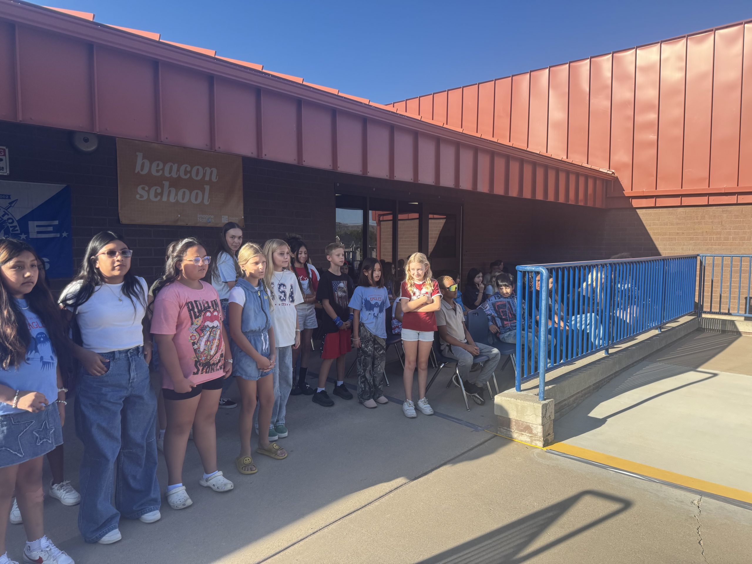 5th grade students standing outside to sing "I'm Proud to Be an American"