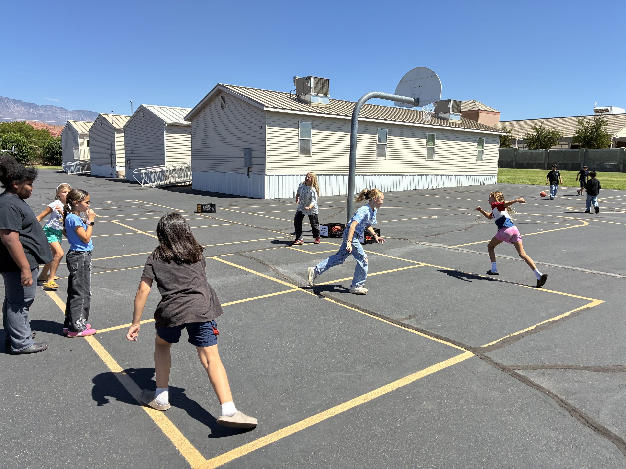 A group of students playing "Switch" on the blacktop at recess