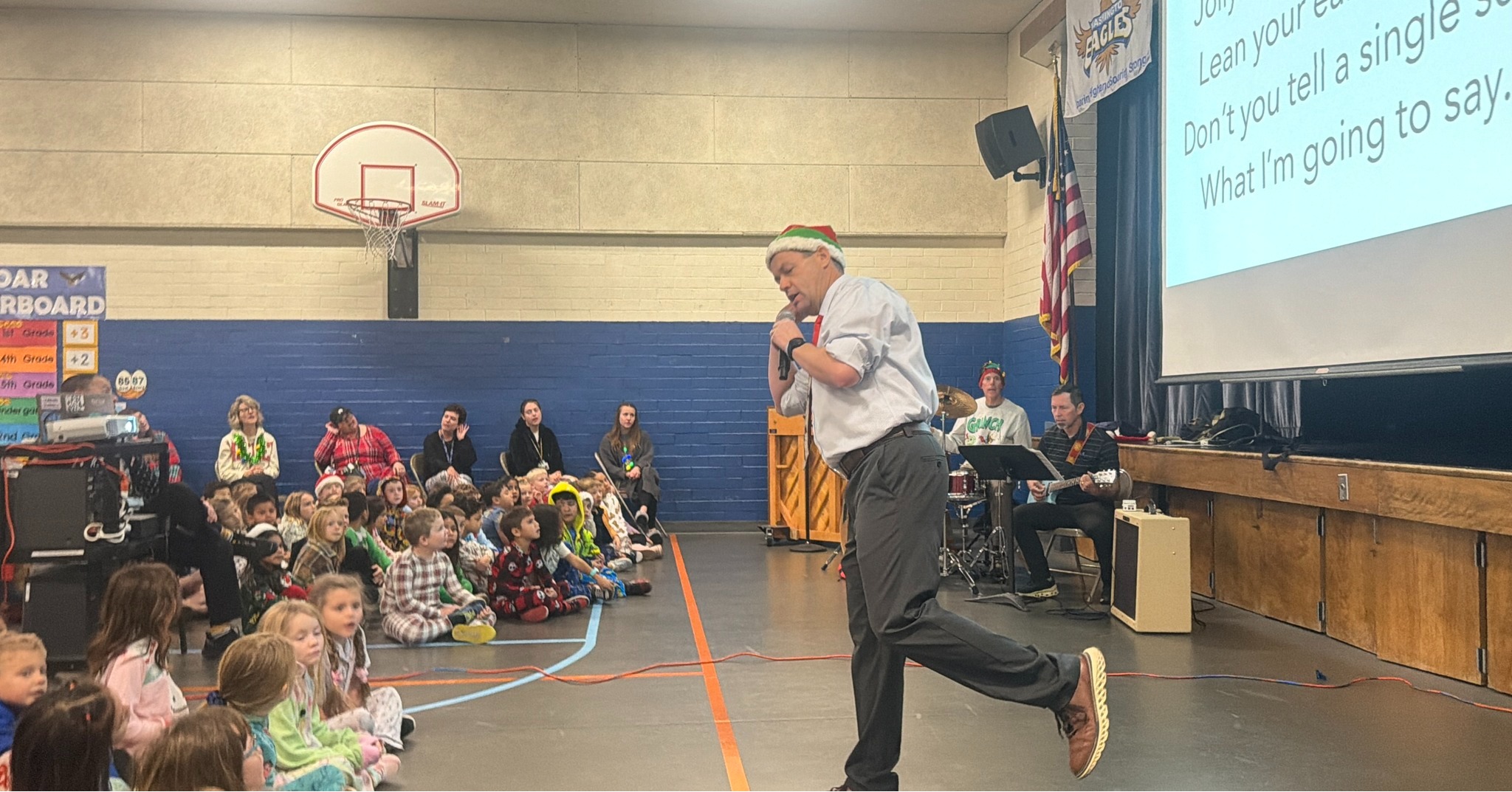Mr. Baker leading the school in singing Christmas songs at our Christmas Sing-Along
