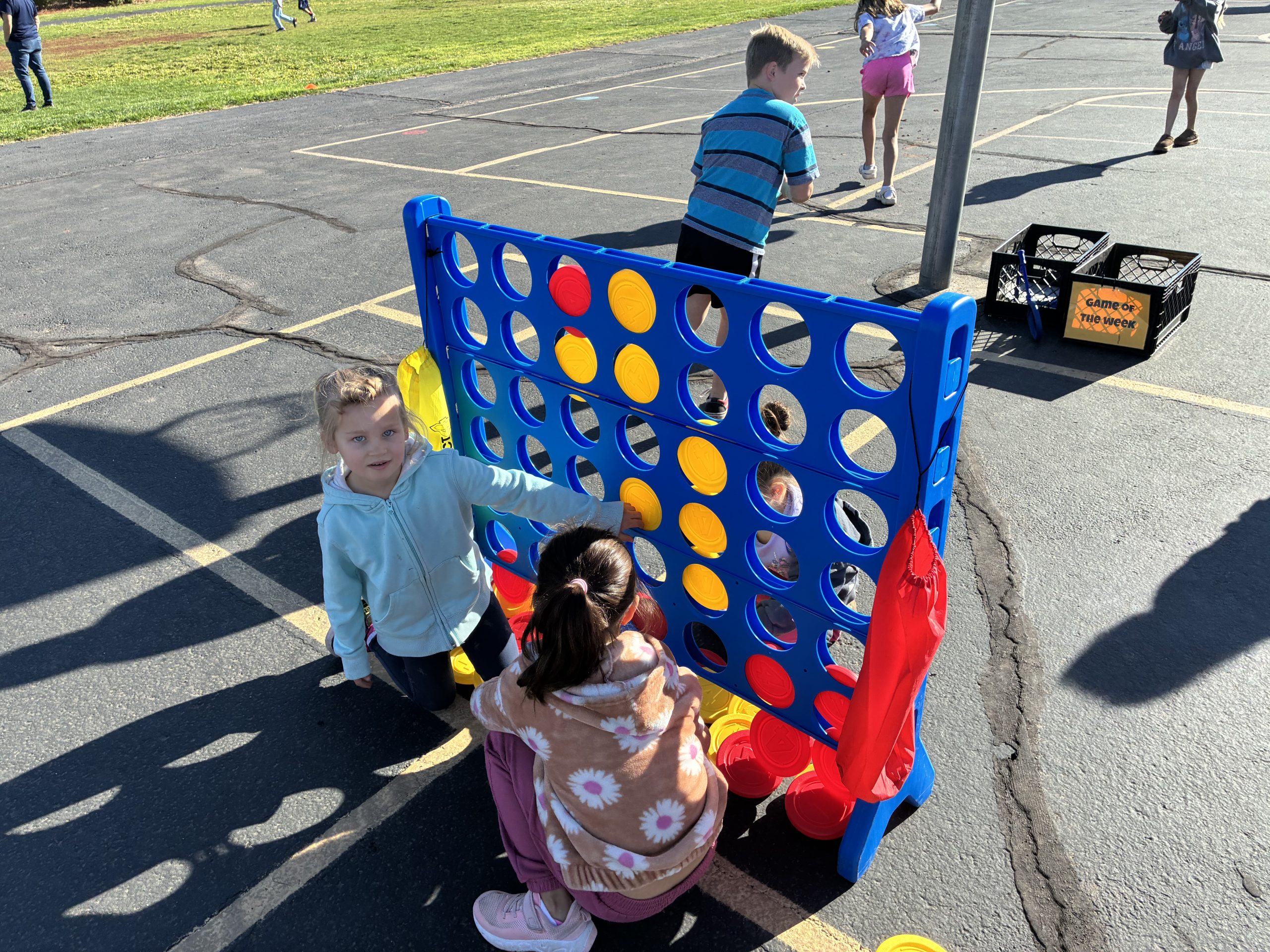 Students playing connect four on the playground